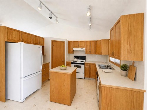 241 Fairway Drive, Coaldale, AB - Indoor Photo Showing Kitchen With Double Sink