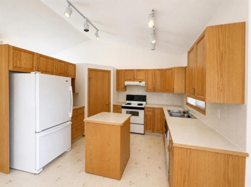 241 Fairway Drive, Coaldale, AB - Indoor Photo Showing Kitchen With Double Sink