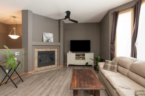 242 Heritage Circle West, Lethbridge, AB - Indoor Photo Showing Living Room With Fireplace