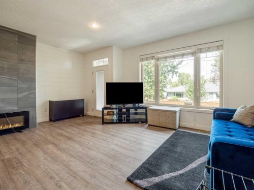 2244 18 Avenue, Coaldale, AB - Indoor Photo Showing Living Room With Fireplace