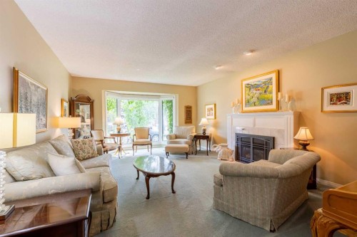 105 Kings Bay South, Lethbridge, AB - Indoor Photo Showing Living Room With Fireplace
