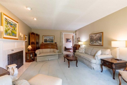 105 Kings Bay South, Lethbridge, AB - Indoor Photo Showing Living Room With Fireplace