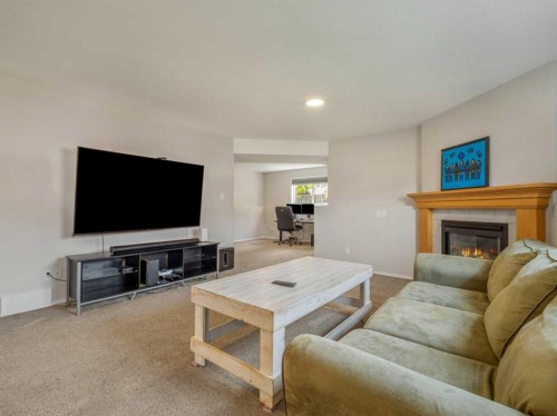 95 Heritage Point West, Lethbridge, AB - Indoor Photo Showing Living Room With Fireplace