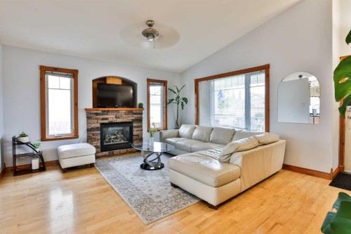 128 Cougar Road North, Lethbridge, AB - Indoor Photo Showing Living Room With Fireplace