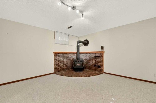 3606 Spruce Drive South, Lethbridge, AB - Indoor Photo Showing Other Room With Fireplace