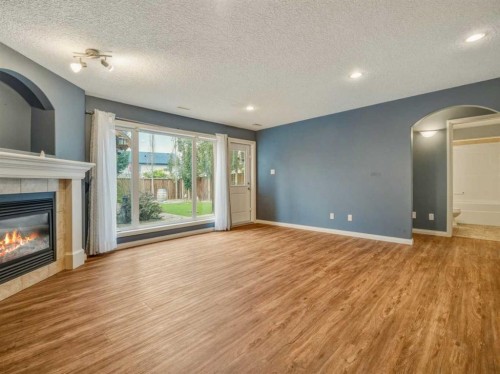 34 Heritage Green West, Lethbridge, AB - Indoor Photo Showing Other Room With Fireplace