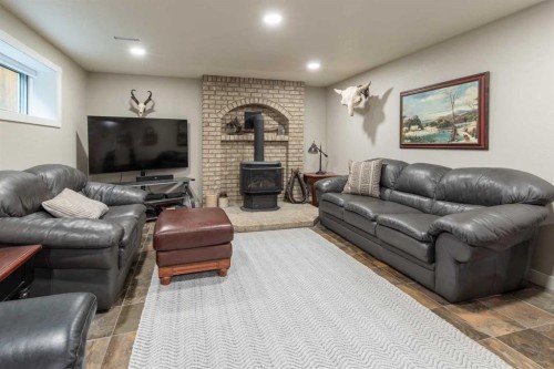 80 N 250 E, Raymond, AB - Indoor Photo Showing Living Room With Fireplace