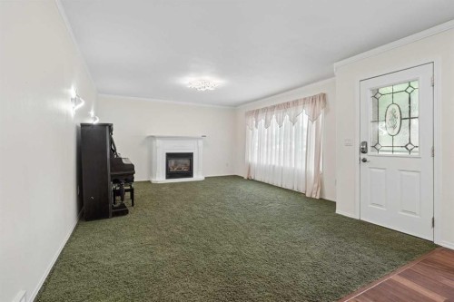 40 N 200 E, Raymond, AB - Indoor Photo Showing Other Room With Fireplace