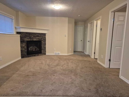 45 Sunridge Boulevard West, Lethbridge, AB - Indoor Photo Showing Other Room With Fireplace