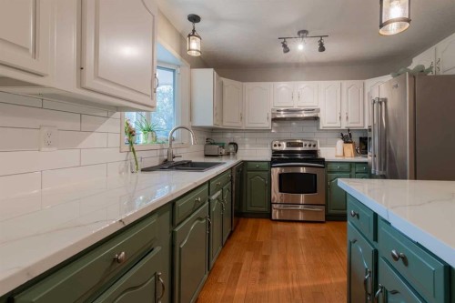 63009 Rr 210, Raymond, AB - Indoor Photo Showing Kitchen With Double Sink