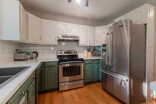 63009 Rr 210, Raymond, AB - Indoor Photo Showing Kitchen With Double Sink