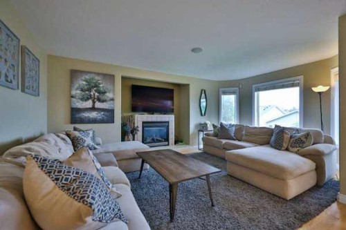 135 Riverbrook Close West, Lethbridge, AB - Indoor Photo Showing Living Room With Fireplace