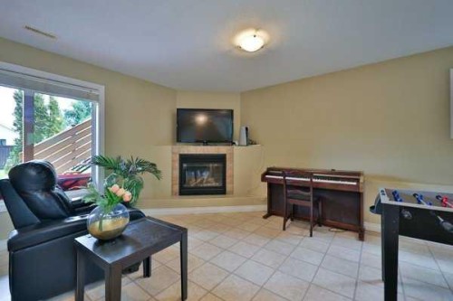 135 Riverbrook Close West, Lethbridge, AB - Indoor Photo Showing Other Room With Fireplace