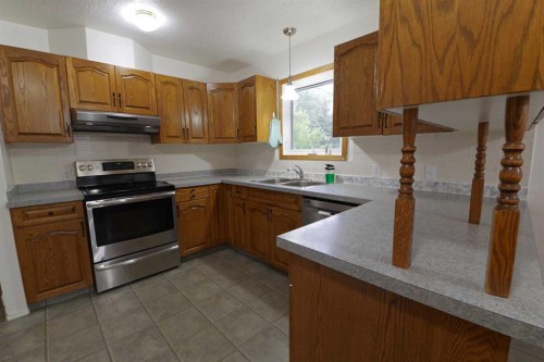 102 1 Avenue, Burdett, AB - Indoor Photo Showing Kitchen With Double Sink