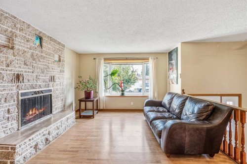 11 Rutgers Crescent West, Lethbridge, AB - Indoor Photo Showing Living Room With Fireplace