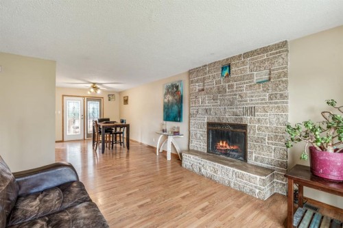 11 Rutgers Crescent West, Lethbridge, AB - Indoor Photo Showing Living Room With Fireplace