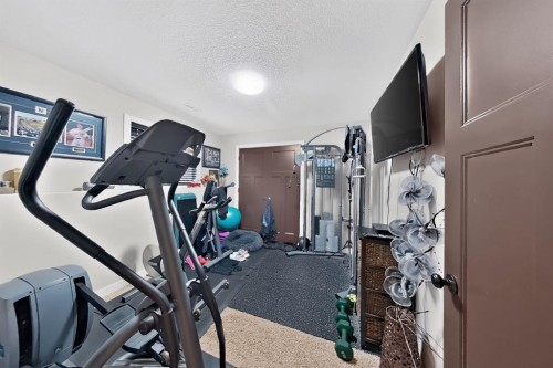 250 Riverstone Boulevard West, Lethbridge, AB - Indoor Photo Showing Gym Room