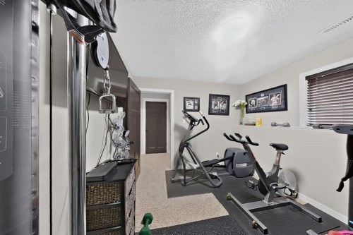 250 Riverstone Boulevard West, Lethbridge, AB - Indoor Photo Showing Gym Room