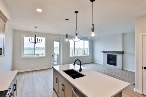 877 Devonia Circle West, Lethbridge, AB - Indoor Photo Showing Kitchen With Fireplace With Double Sink