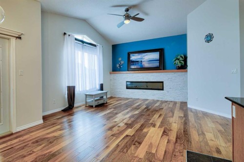 544 Couleesprings Crescent South, Lethbridge, AB - Indoor Photo Showing Living Room With Fireplace