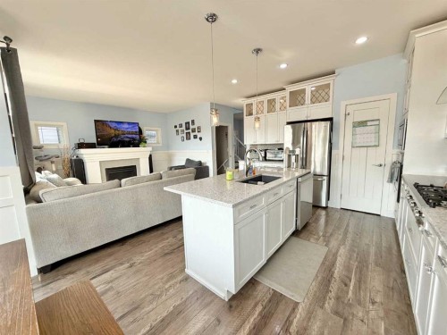 55 Riverhurst Cove West, Lethbridge, AB - Indoor Photo Showing Kitchen With Fireplace With Upgraded Kitchen