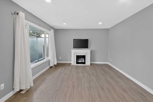 2110 15 Avenue South, Lethbridge, AB - Indoor Photo Showing Other Room With Fireplace
