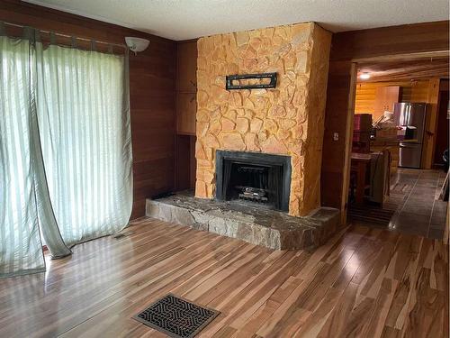 83105 Highway 735, Rural Clear Hills County, AB - Indoor Photo Showing Living Room With Fireplace
