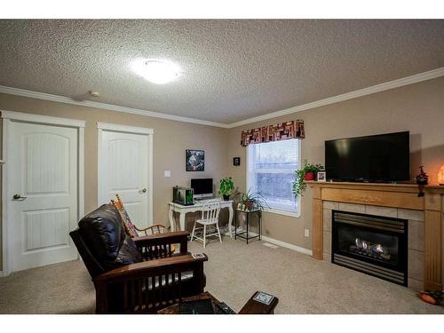 6-10709 108 Avenue, Fairview, AB - Indoor Photo Showing Living Room With Fireplace
