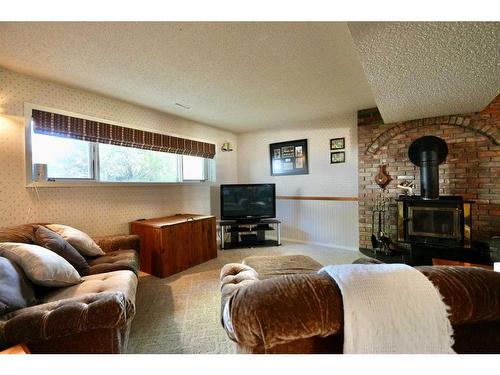 10009 71 Avenue, Peace River, AB - Indoor Photo Showing Living Room With Fireplace