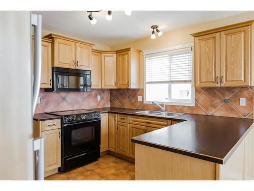 42 Pinnacle Street, Grande Prairie, AB - Indoor Photo Showing Kitchen With Double Sink