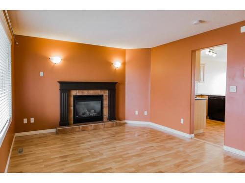 42 Pinnacle Street, Grande Prairie, AB - Indoor Photo Showing Living Room With Fireplace