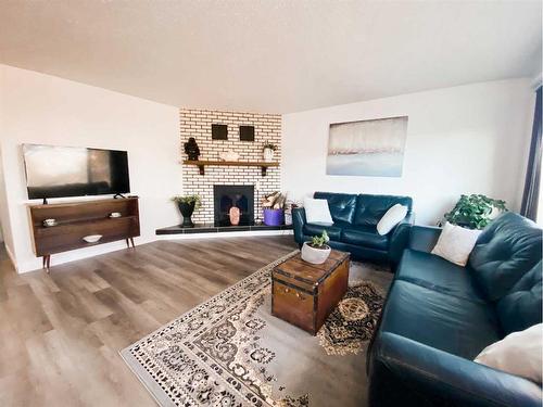 14 Sunset Drive, Spirit River, AB - Indoor Photo Showing Living Room With Fireplace