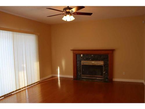 10722 91 Street, Peace River, AB - Indoor Photo Showing Living Room With Fireplace
