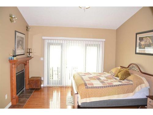 11201 67 Street, Peace River, AB - Indoor Photo Showing Bedroom With Fireplace