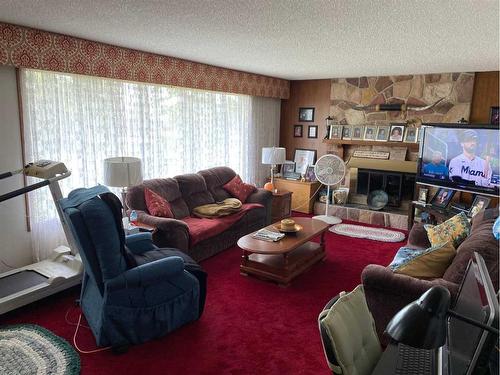 5120 46 Avenue, Spirit River, AB - Indoor Photo Showing Living Room With Fireplace