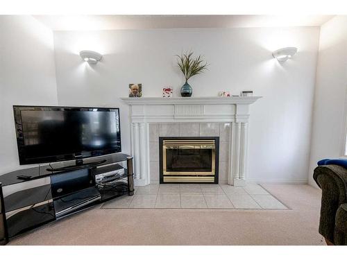 6122 98 Street, Grande Prairie, AB - Indoor Photo Showing Living Room With Fireplace