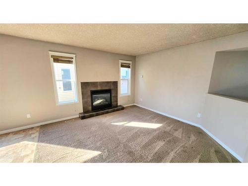 6915 112 Street, Grande Prairie, AB - Indoor Photo Showing Other Room With Fireplace