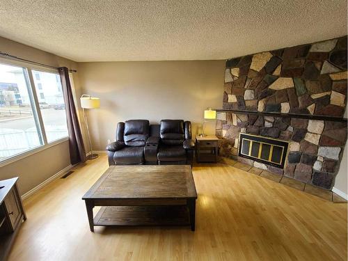 8005A 99 Street, Peace River, AB - Indoor Photo Showing Living Room With Fireplace