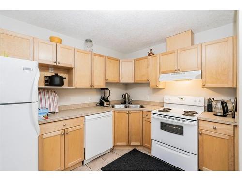 106-9810 96 Street, Grande Prairie, AB - Indoor Photo Showing Kitchen With Double Sink