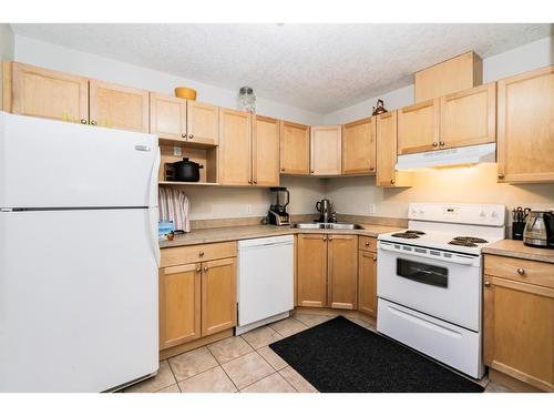 106-9810 96 Street, Grande Prairie, AB - Indoor Photo Showing Kitchen With Double Sink