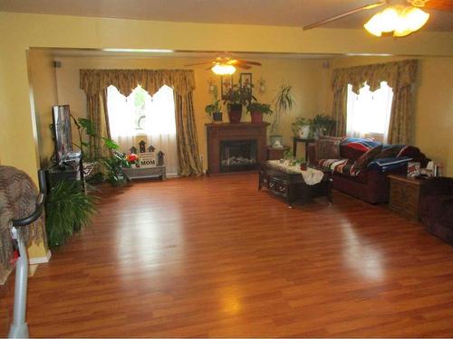 #308 6Th Avenue Se, Manning, AB - Indoor Photo Showing Living Room With Fireplace
