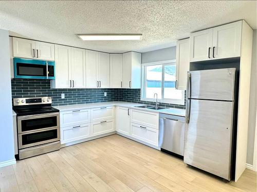 11402 Norris Crescent, Grande Cache, AB - Indoor Photo Showing Kitchen With Stainless Steel Kitchen With Double Sink