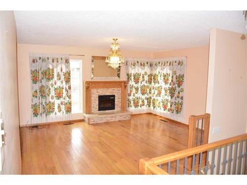 9621 83 Avenue, Peace River, AB - Indoor Photo Showing Living Room With Fireplace
