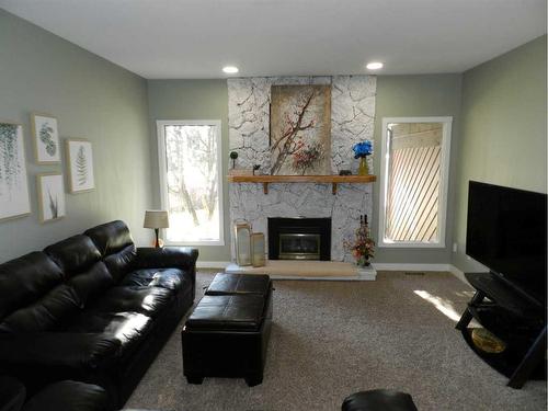 10022 84 Street, Peace River, AB - Indoor Photo Showing Living Room With Fireplace