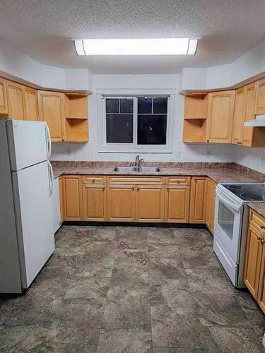 12902 94 Street, Grande Prairie, AB - Indoor Photo Showing Kitchen With Double Sink