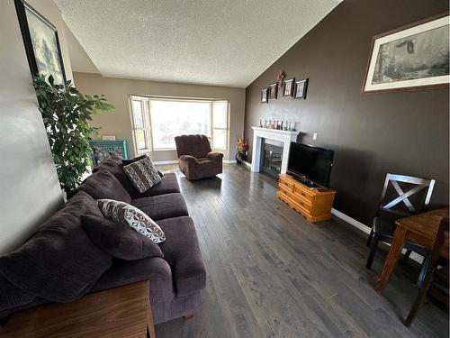 10010 85 Street, Peace River, AB - Indoor Photo Showing Living Room With Fireplace