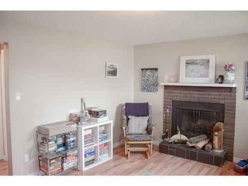 7727 95 Street, Grande Prairie, AB - Indoor Photo Showing Living Room With Fireplace