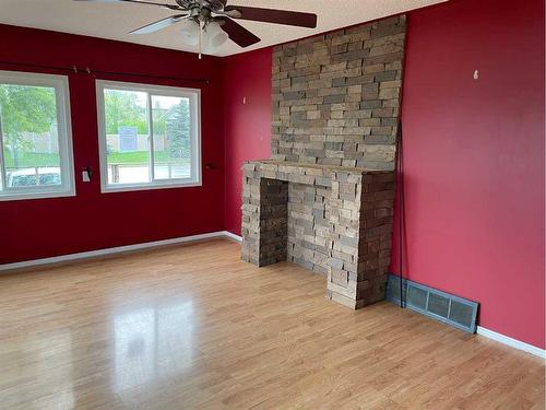 10909 105 Avenue, Fairview, AB - Indoor Photo Showing Other Room With Fireplace