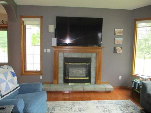 220037-692 Road East, Rural Northern Lights, County Of, AB - Indoor Photo Showing Living Room With Fireplace