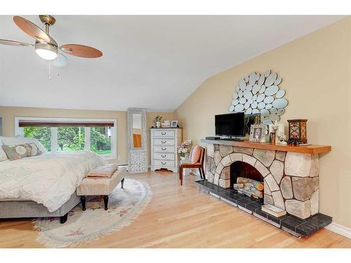 9906 105 Avenue, Grande Prairie, AB - Indoor Photo Showing Bedroom With Fireplace